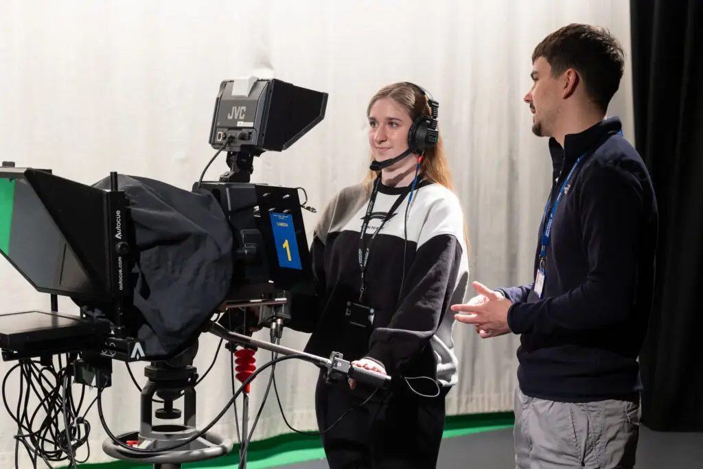 film and media production students behind a camera