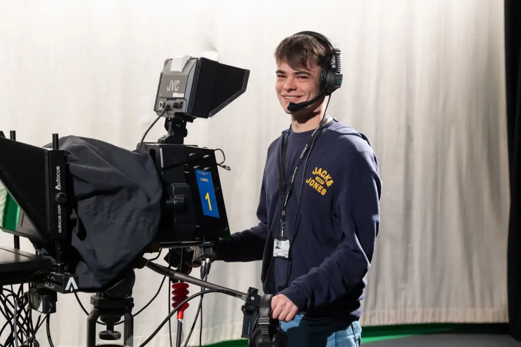 film and media production student behind a camera