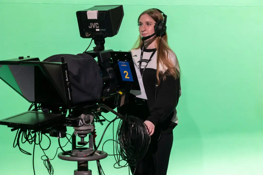 film and media production student behind a camera