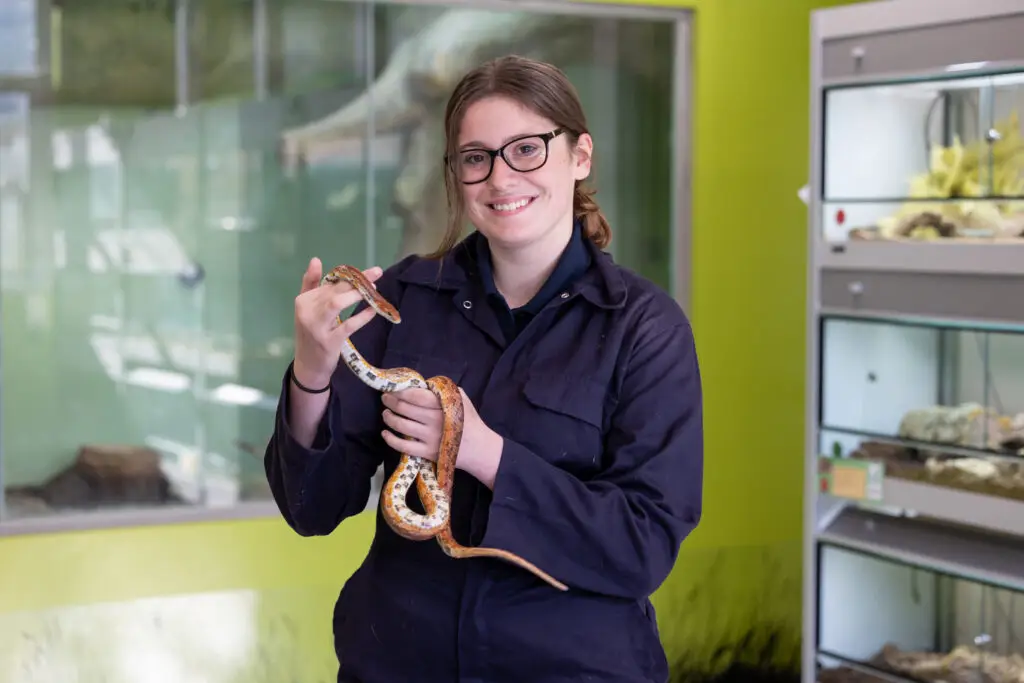 Student holding snake