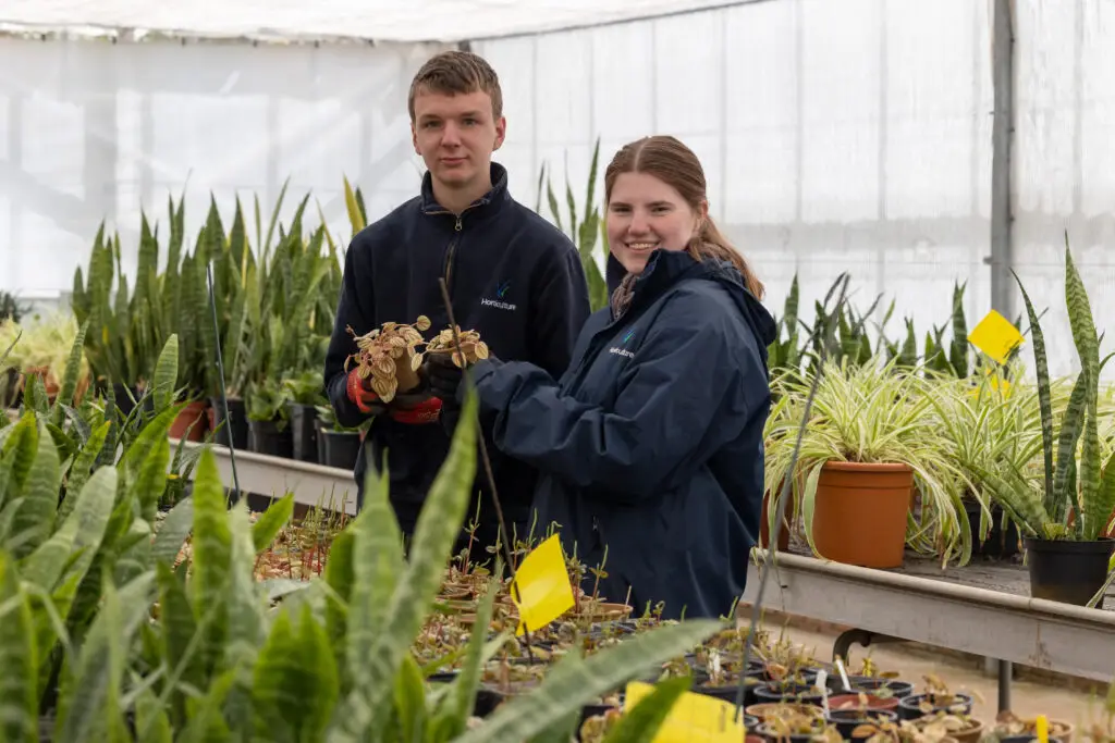 two students gardening