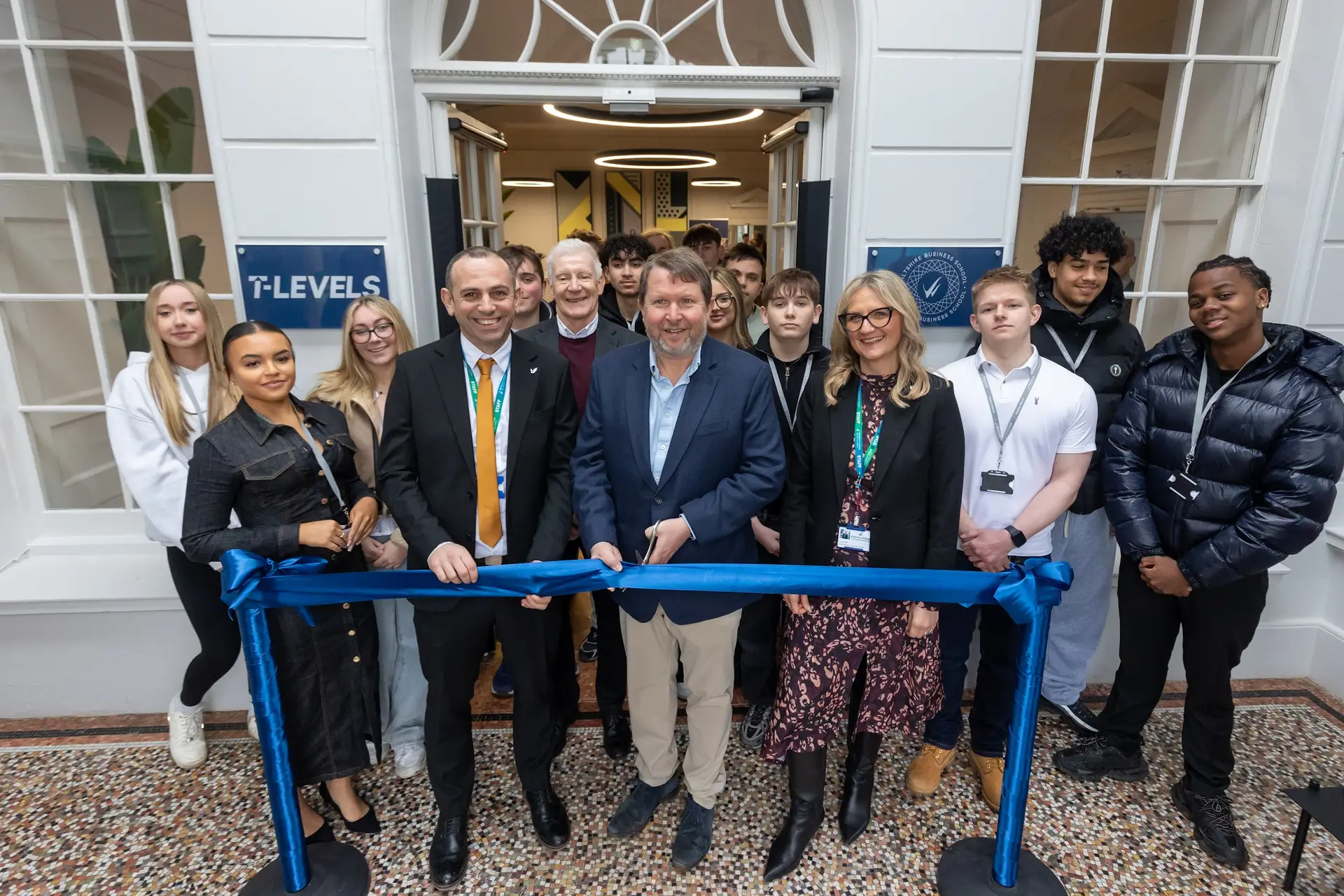 Entrepreneur Nick Jenkins cuts the ribbon at the opening of Wiltshire College & University Centre’s Wiltshire Business School with Principal & CEO Iain Hatt, watched by guests and students