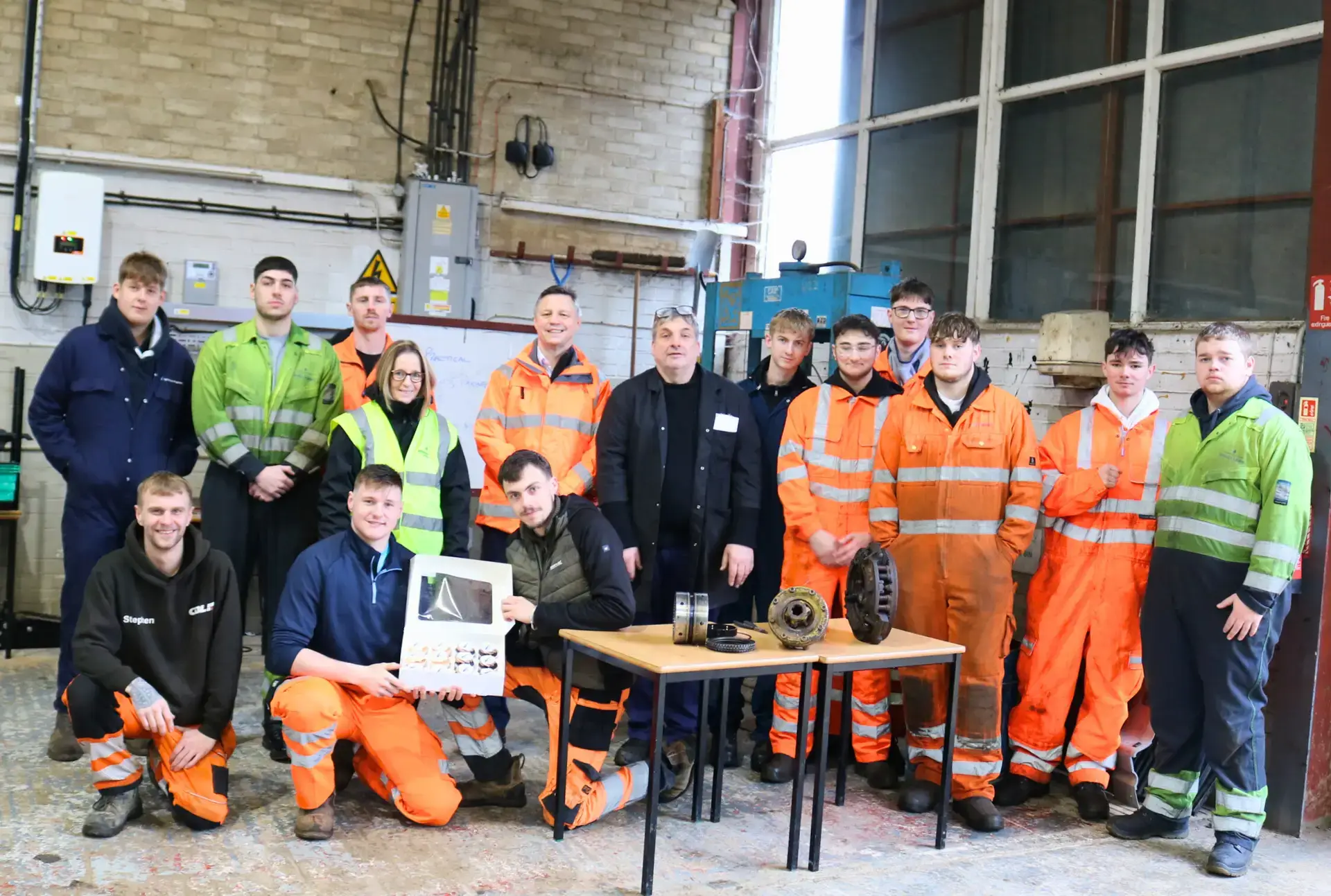 Engineering students holding cakes