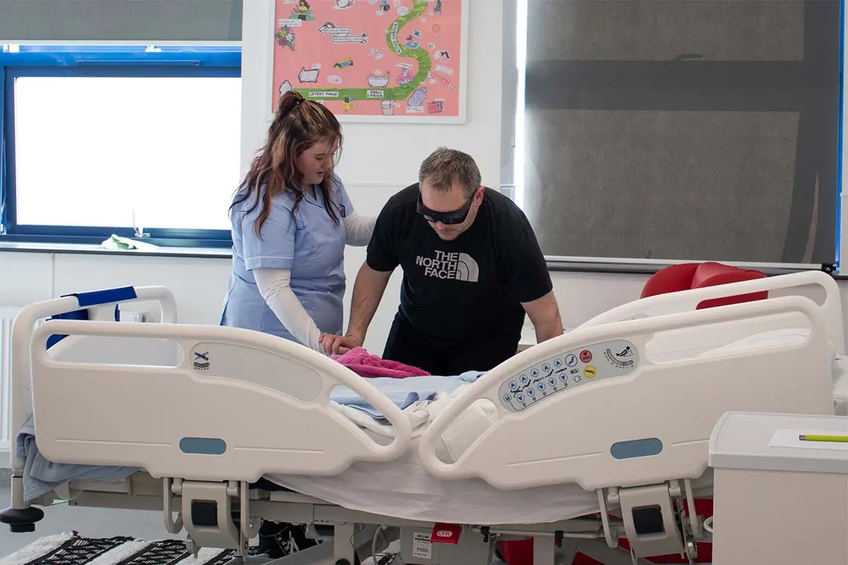 Woman helping man at hospital