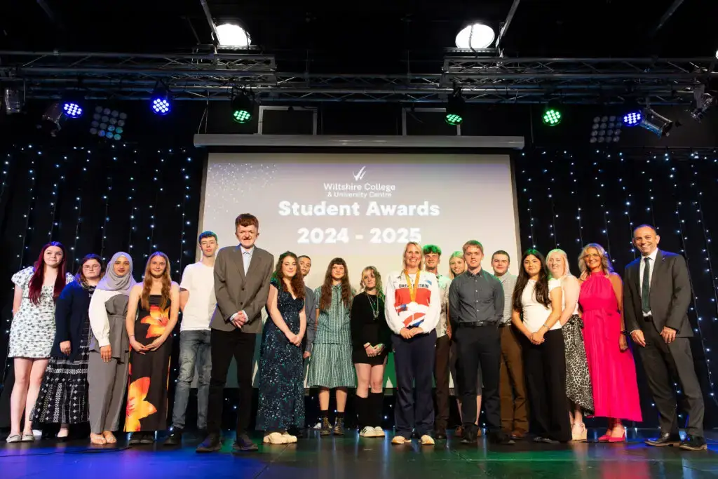 Group of WCUC students holding awards and celebrating against a back drop that reads Student Awards 2024 - 2025.