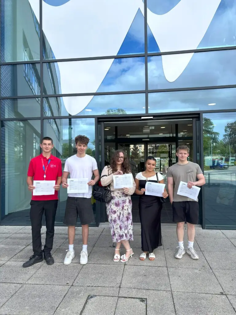 Group of T Level Business students celebrating their successful results