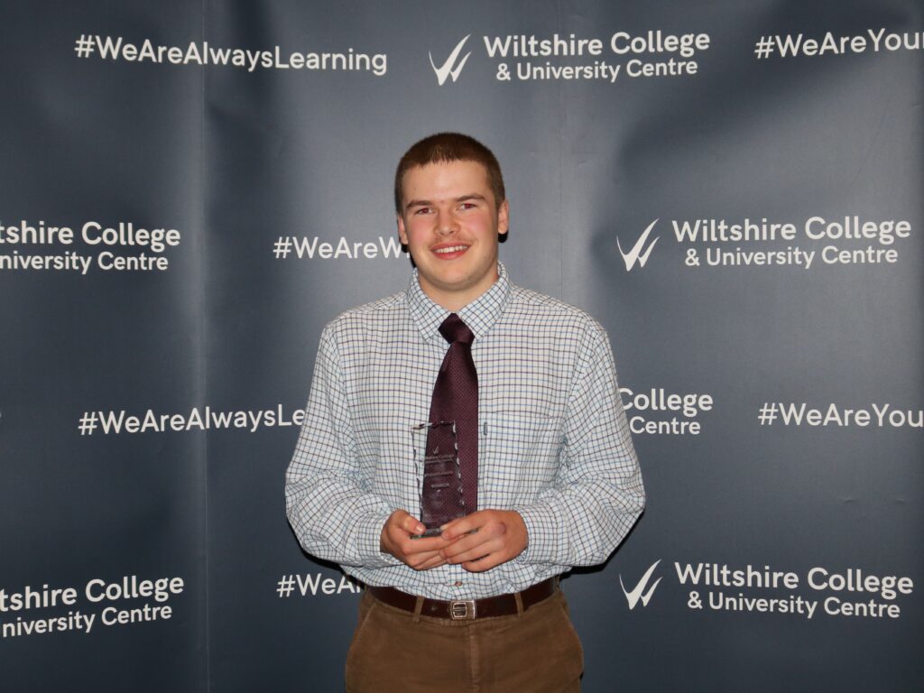 Student holding an award