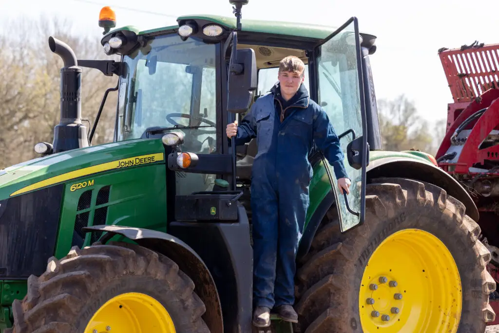 Student stepping out of a tractor