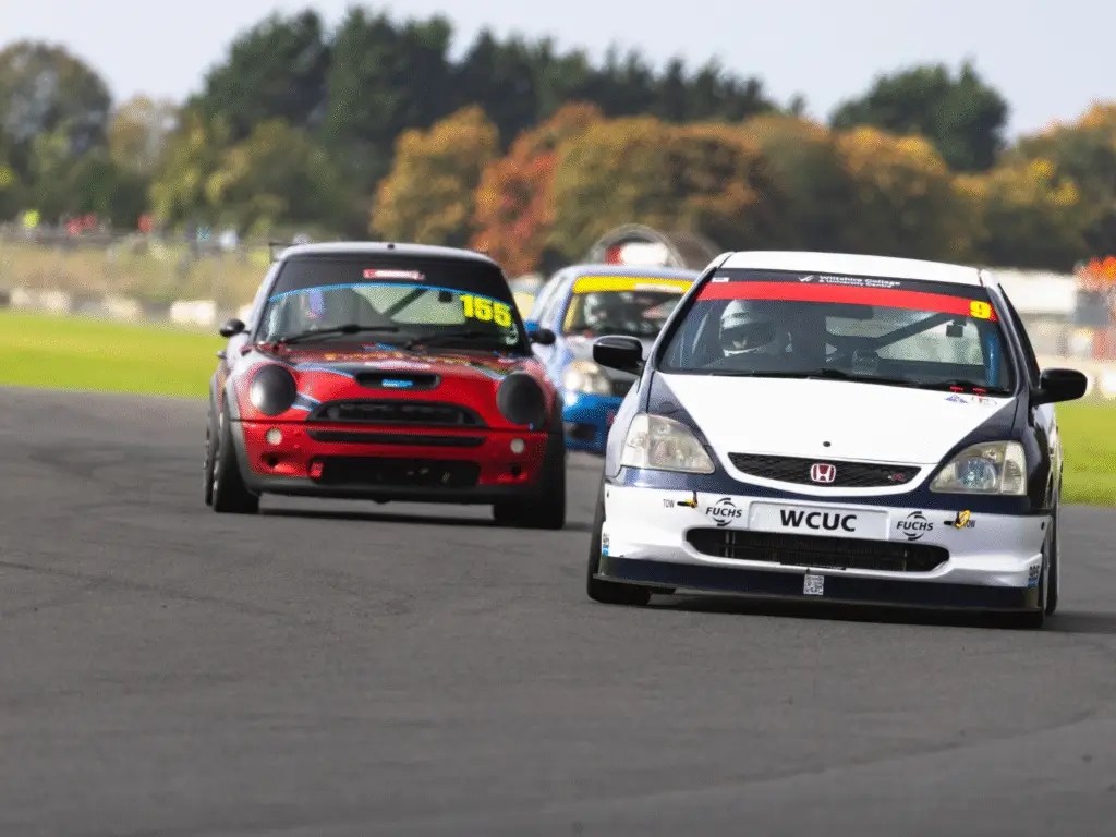 Two cars racing at Castle Combe 