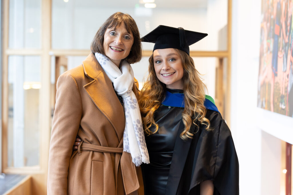 Wiltshire College Graduand with a family member smiling
