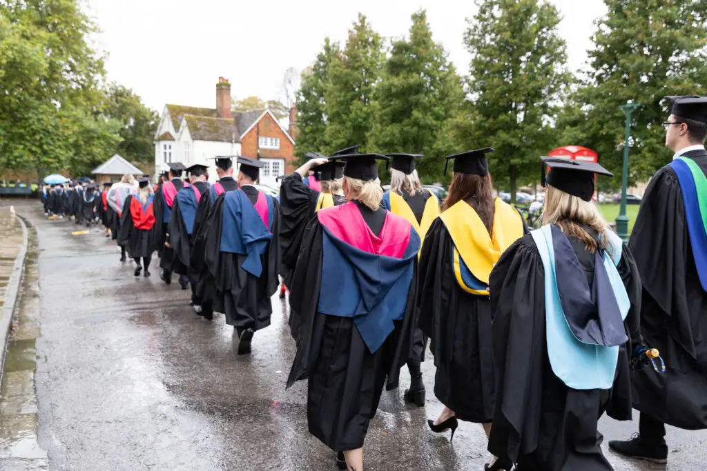 Wiltshire College Graduands lined up and walking through the street, heading to Salisbury Cathedral.