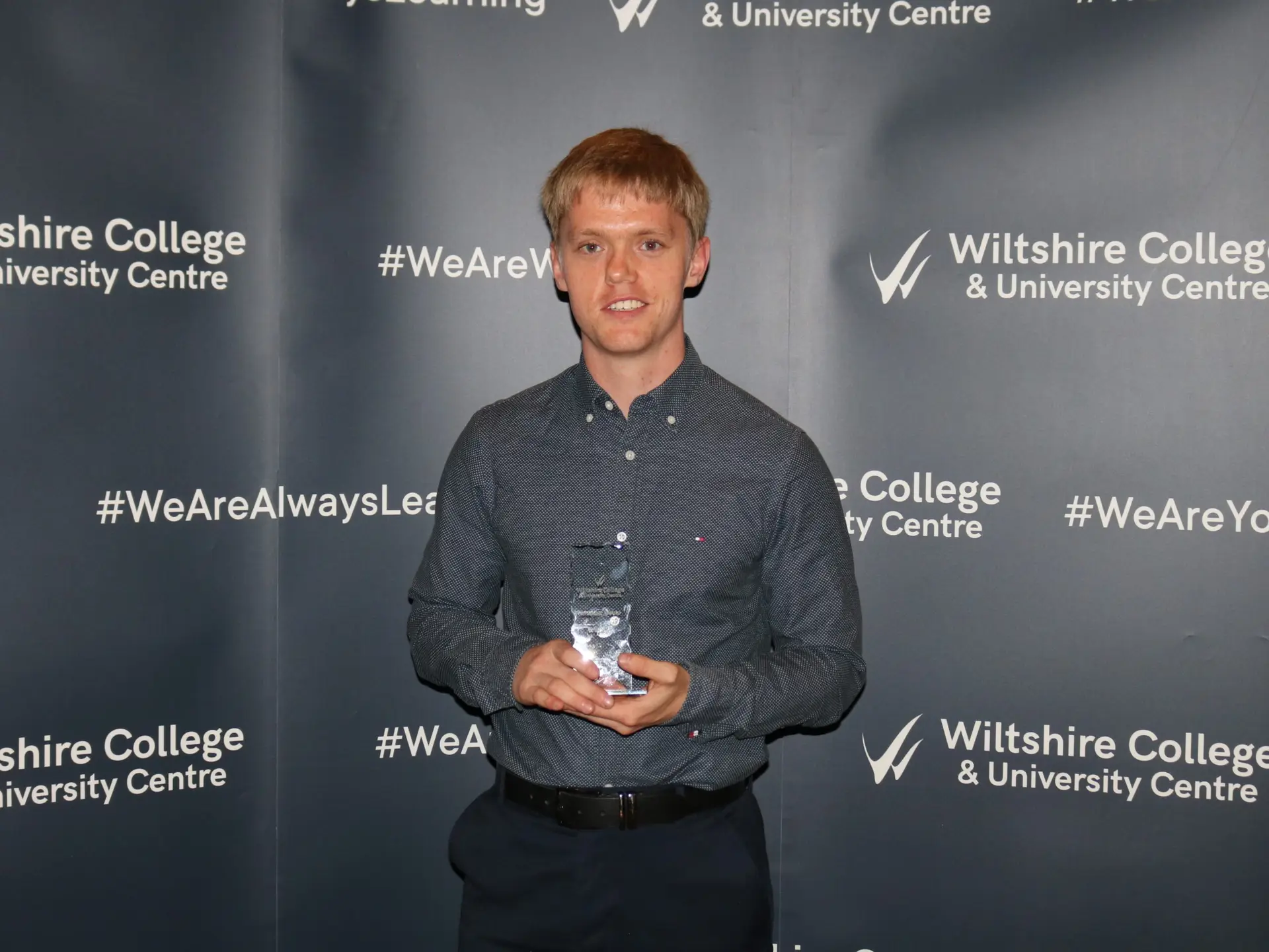 Alex Nuttall holding his glass trophy from Student Awards 2024/25