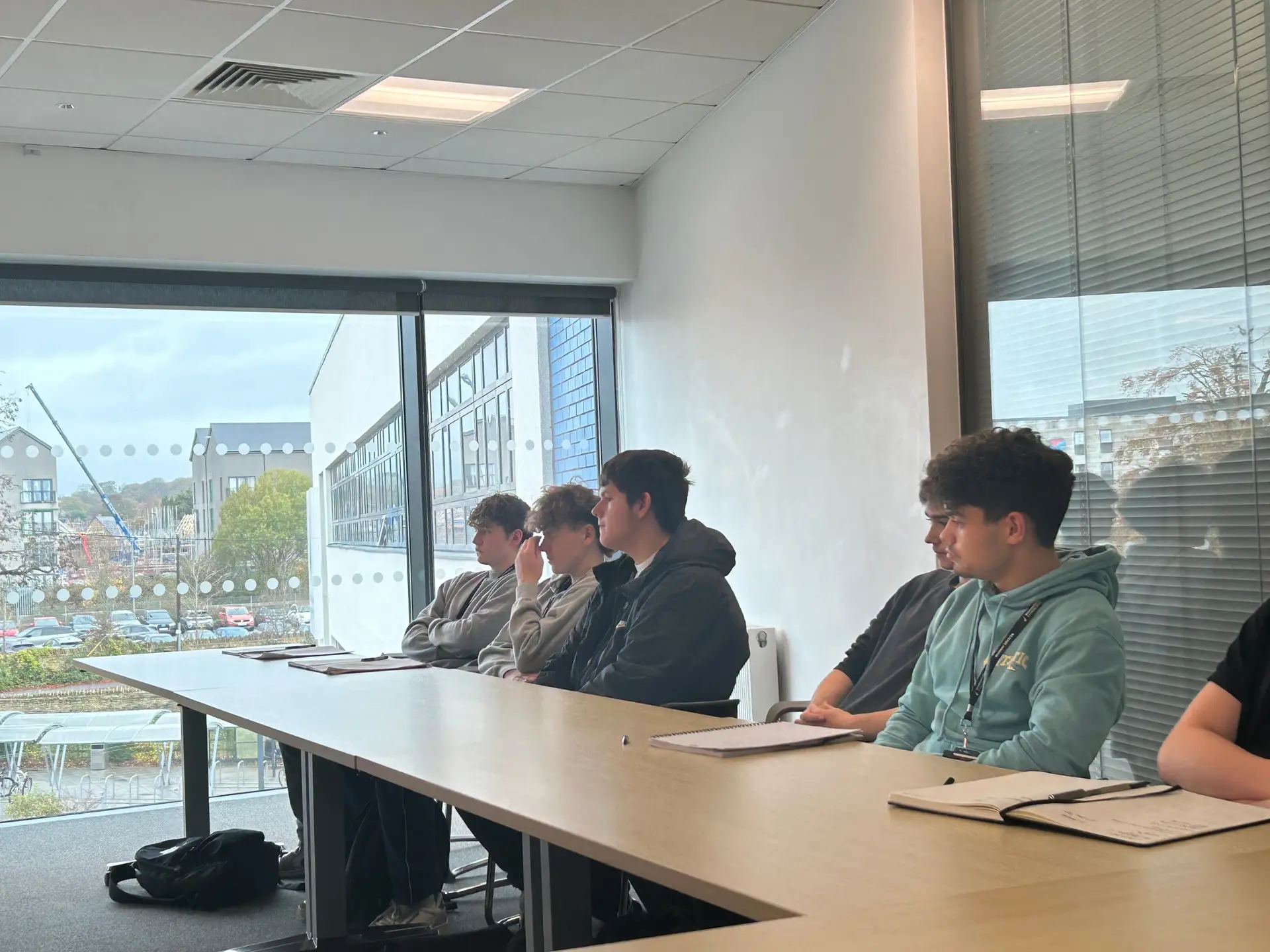 Engineering students seated in a classroom taking notes during an employer presentation at Wiltshire College & University Centre.