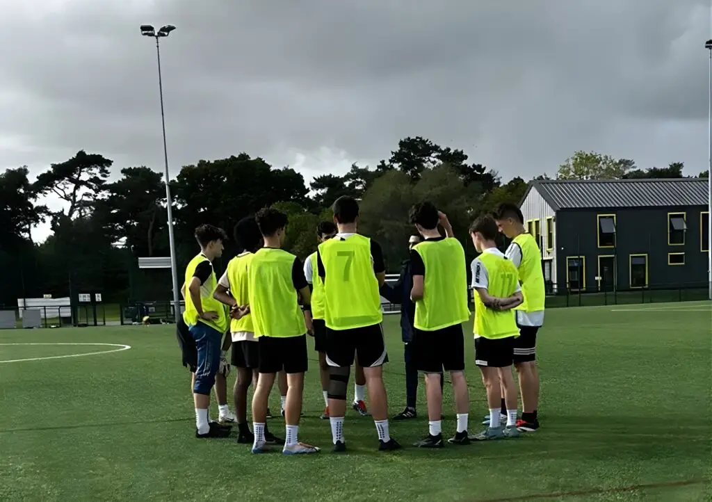 Wiltshire College football academy players gathered on a 3G pitch during training.