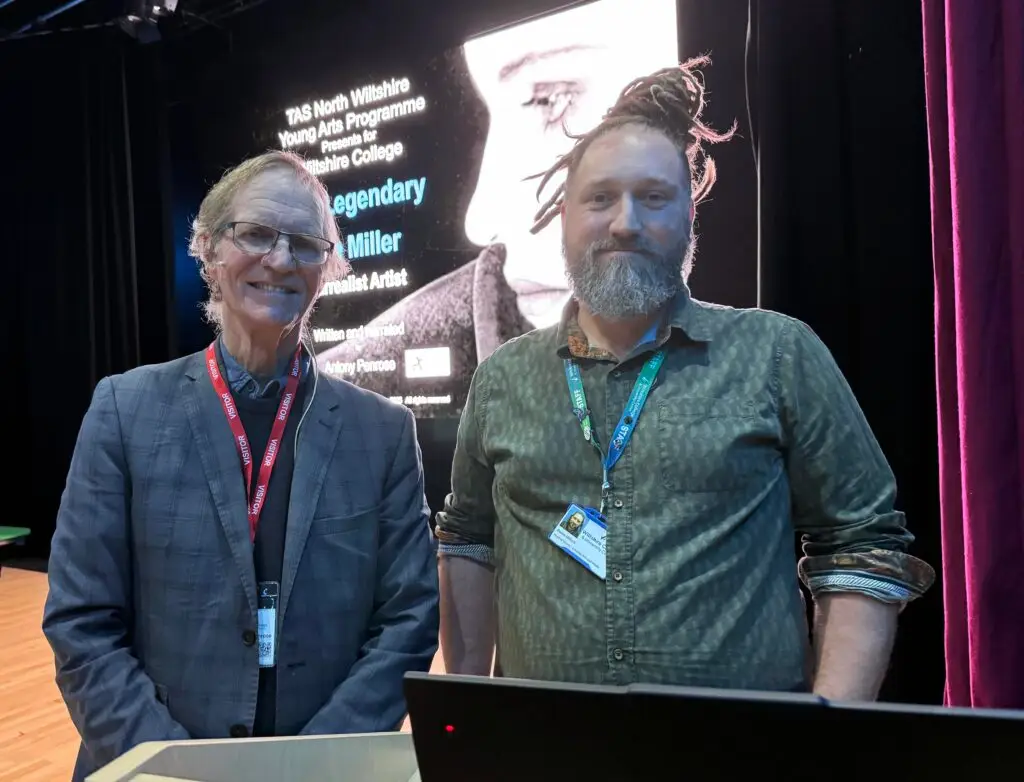 Antony Penrose standing with a member of Wiltshire College staff on stage at the Trowbridge campus before his talk on Lee Miller.
