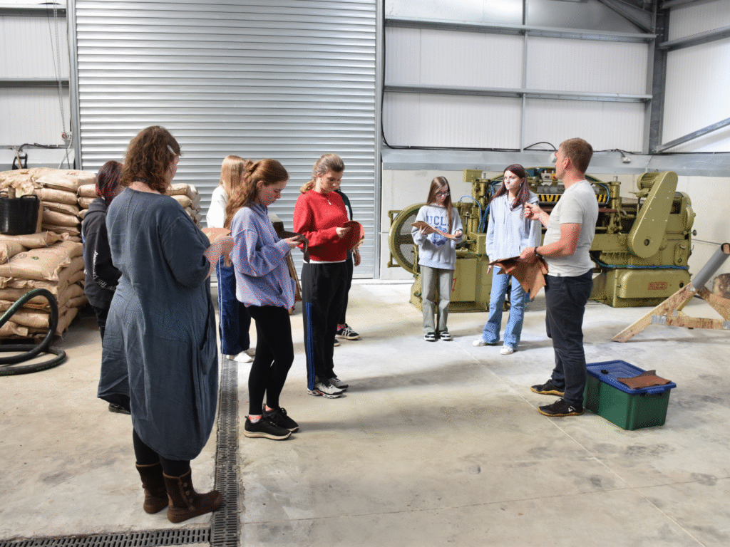 Fashion students listen at a workshop at Great Cotmarsh Farm.