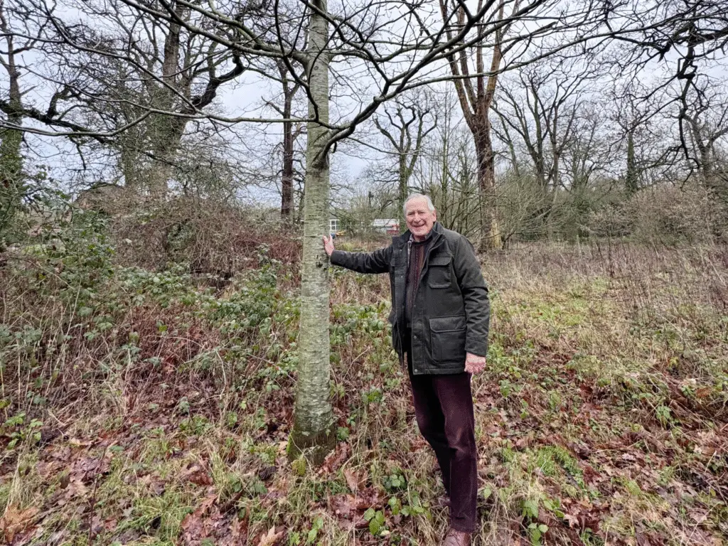 Former Chair Geoff Burgess standing beside an oak tree at Wiltshire College’s Lackham campus
