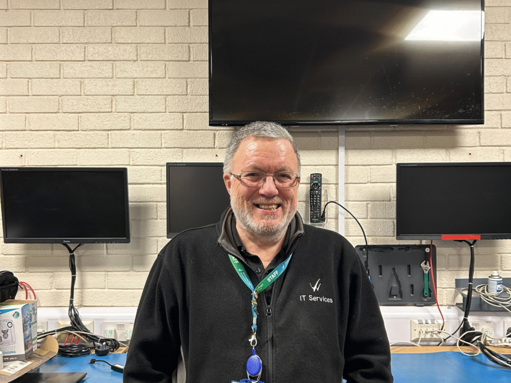Chris Holt standing in an IT workspace at Wiltshire College