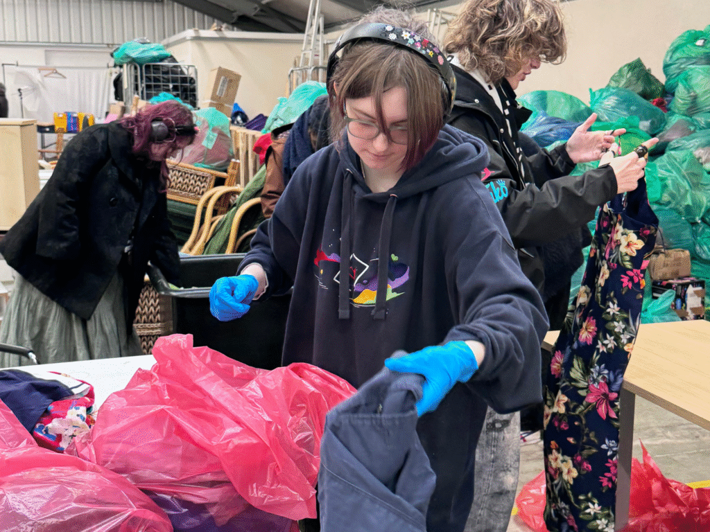 Students from Wiltshire College & University Centre sort donated clothing at Dorothy House’s warehouse as part of a sustainable fashion project.