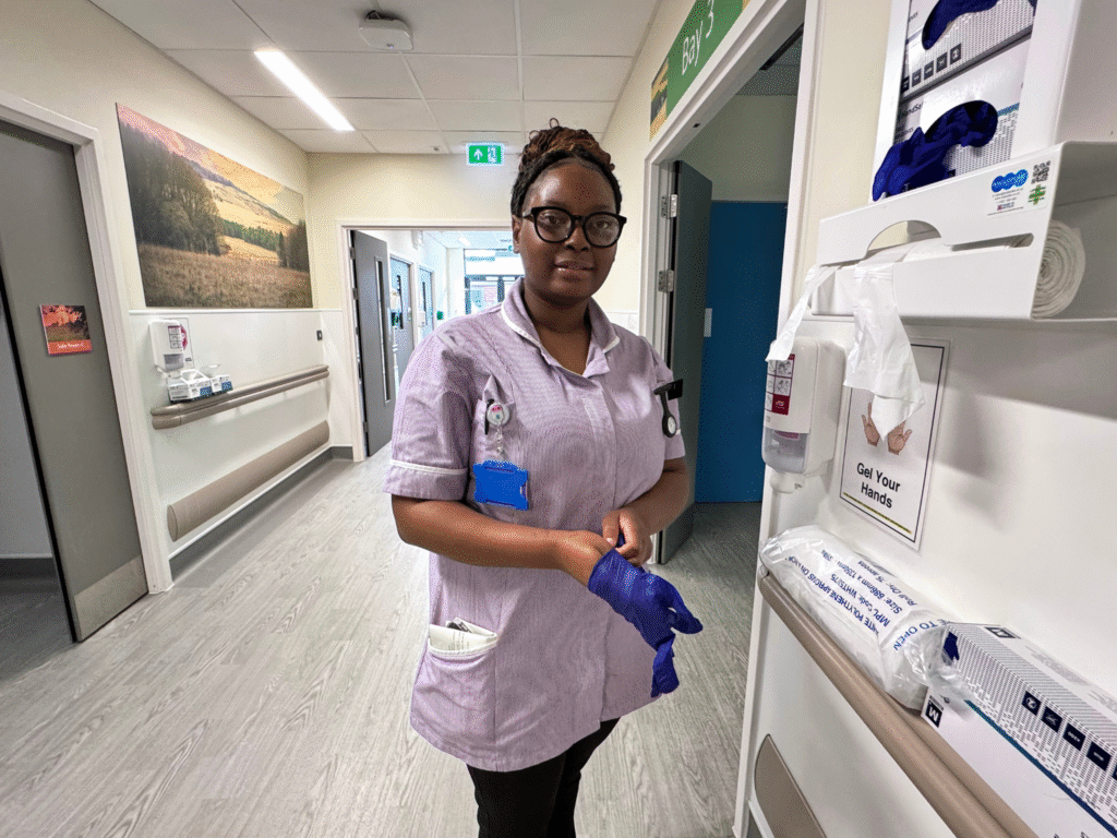 Nursing student pulls on her gloves ready for another task