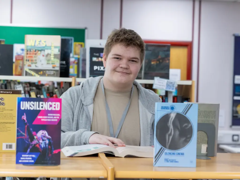 Student in campus library, exploring books