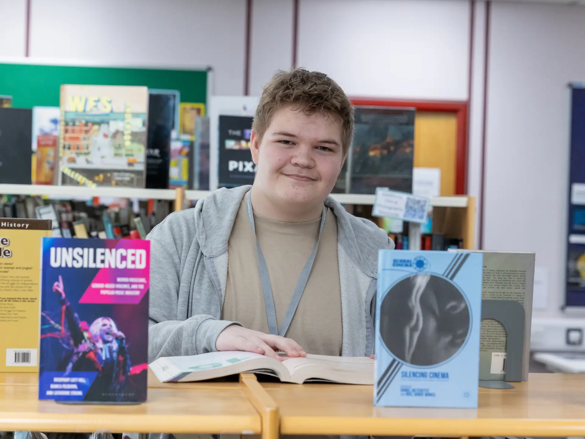 Student in campus library, exploring books