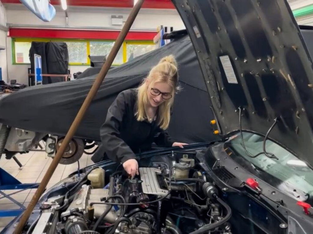 Student working on a car engine during a motorsport engineering practical session at Wiltshire College & University Centre