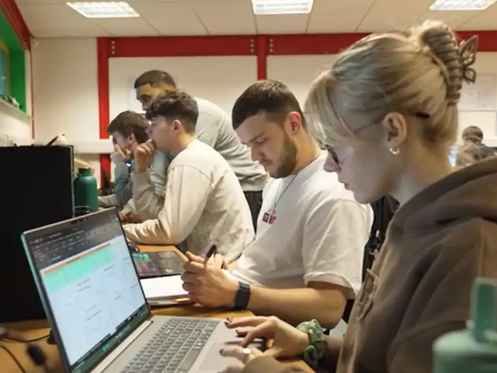 Students working on laptops during a motorsport engineering lesson at Wiltshire College & University Centre