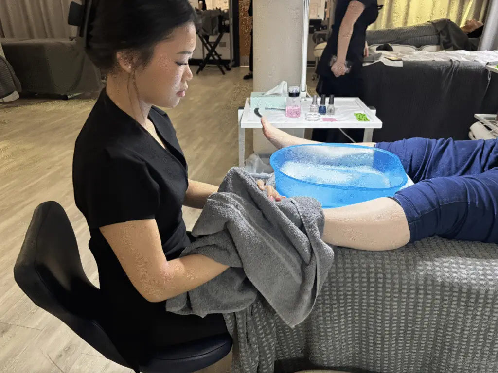 Unpaid carer receiving a pedicure from college student