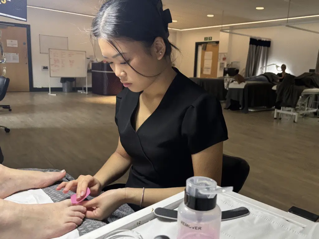 student doing a pedicure of unpaid carer