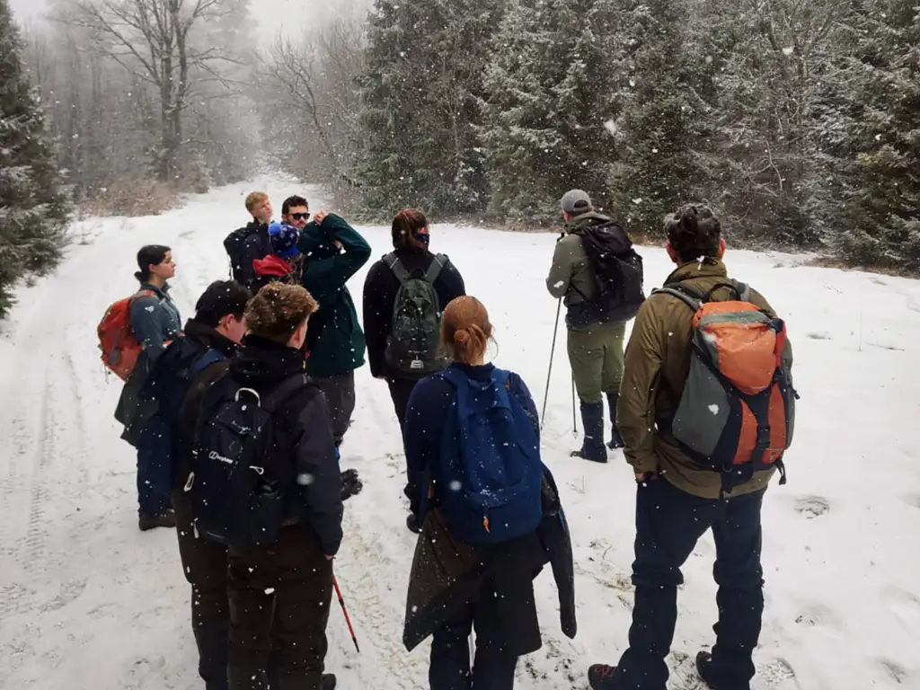 Students standing in the snow on a trip to Poland