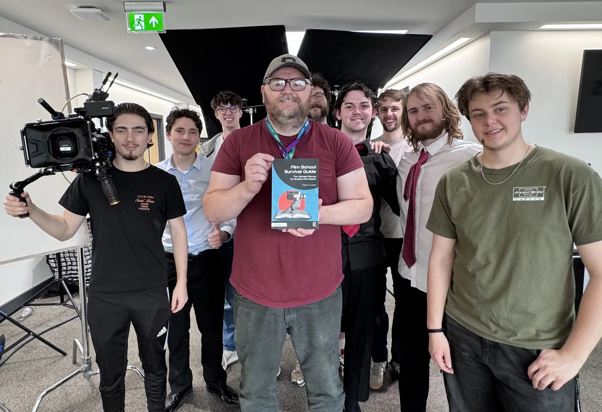 Lecturer with his new book and his students
