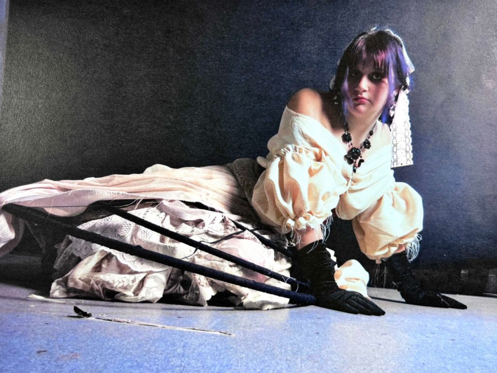 A model led on her side with a black and white dress on 
