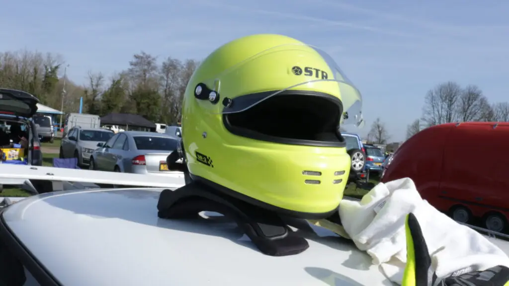 A yellow helmet on top of a car