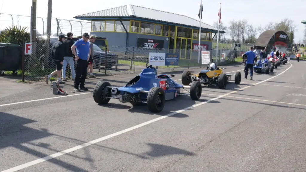A group of cars racing on the track