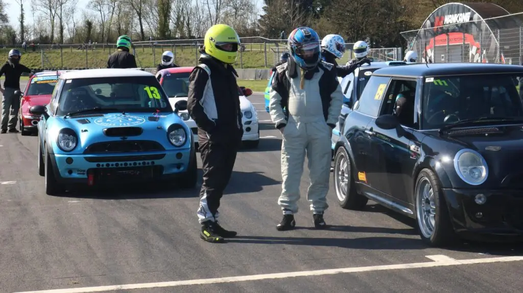 Drivers geared up on track in between cars