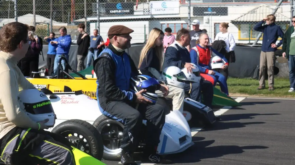 Drivers sat on their cars posing for pictures.