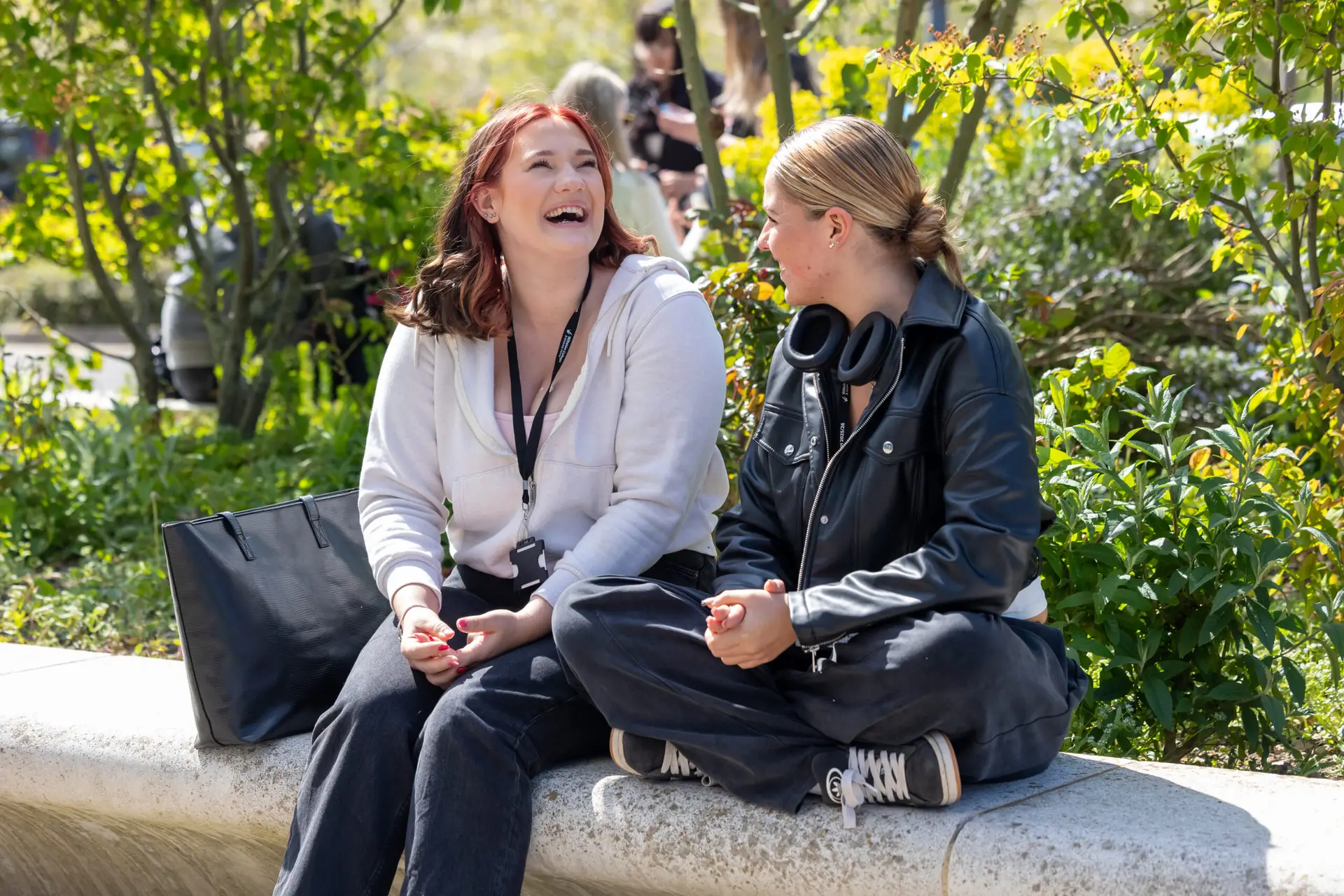 Two students sat outside laughing