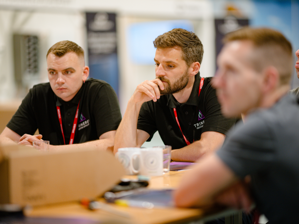 Inatallers gathered around a table for training on the Luthmore One boiler at the Green Skills Innovation Centre at Wiltshire College & University Centre