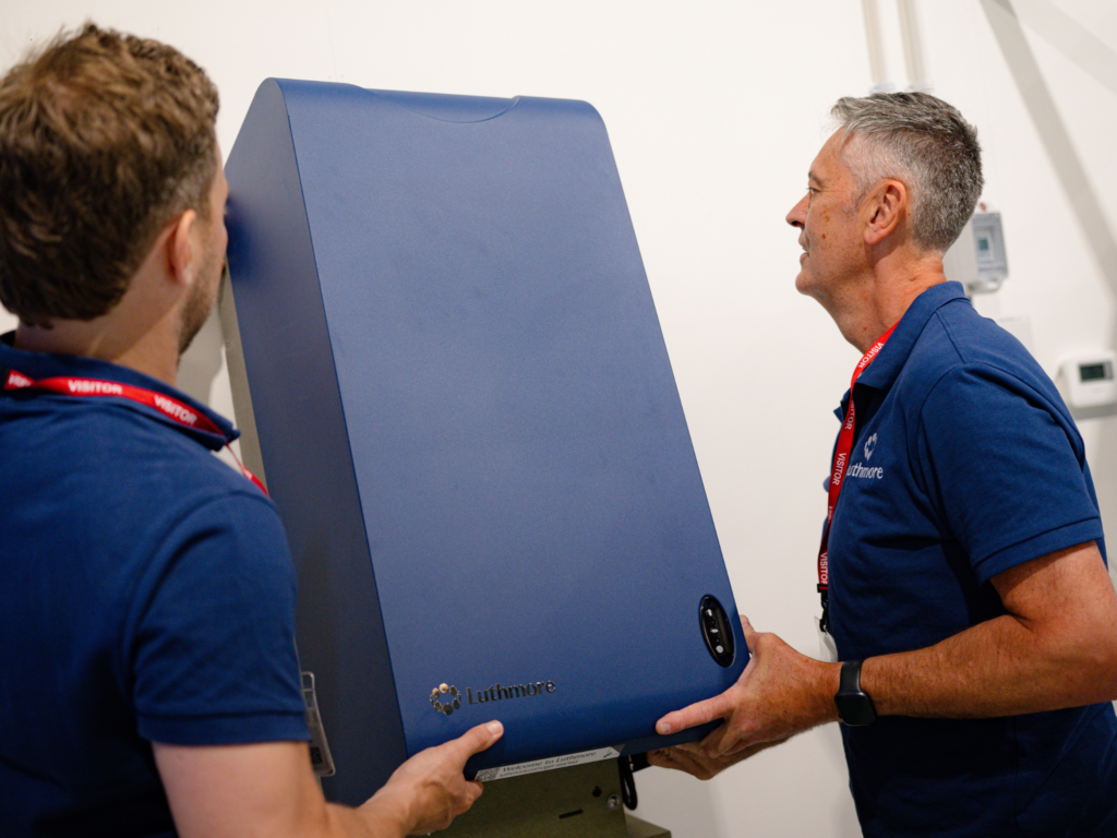 Two men installing the Luthmore One boiler.