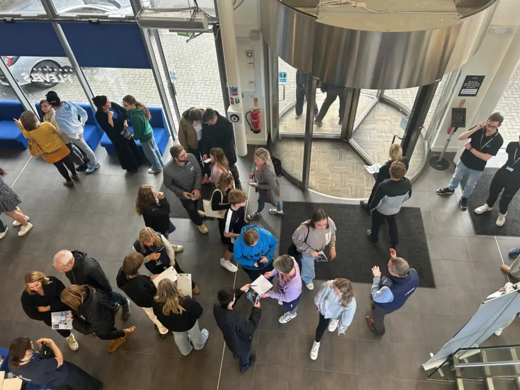 Aerial shot of an open event - people gathered, talking.
