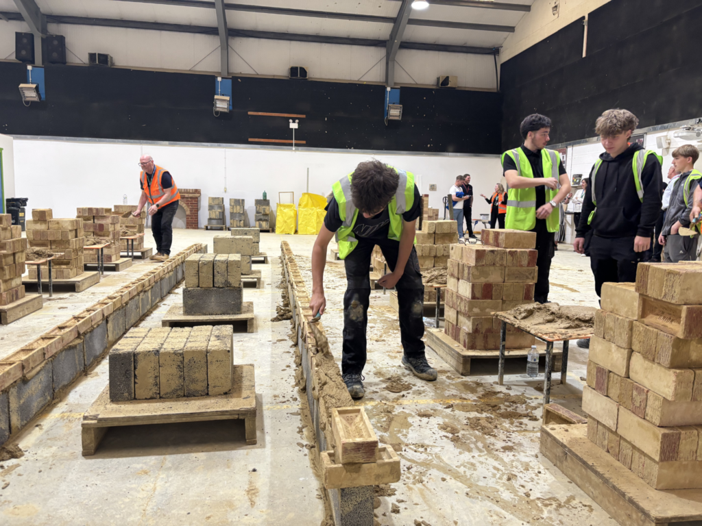 Bricklaying students take part in a competition against lecturers.