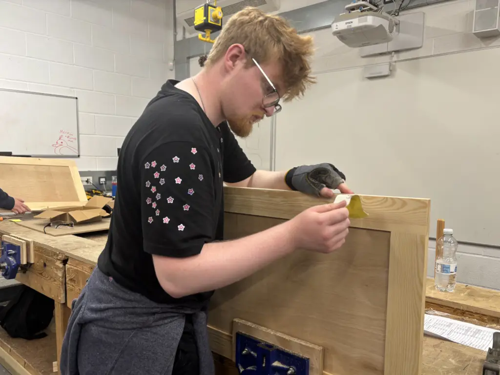 Construction student working on the utility build for the College's Construction Skills Competition