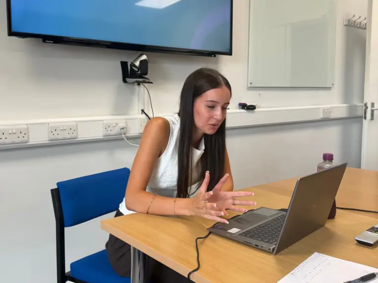 A T Level Management and Administration student at Wiltshire College & University Centre, working on a laptop during her industry placement at CMS Group.