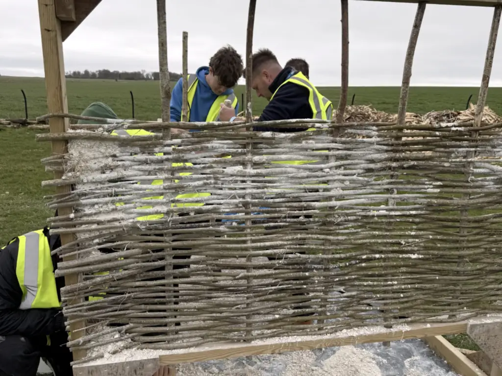Carpentry and joinery students taking part in a hurdle-making activity at Stonehenge.