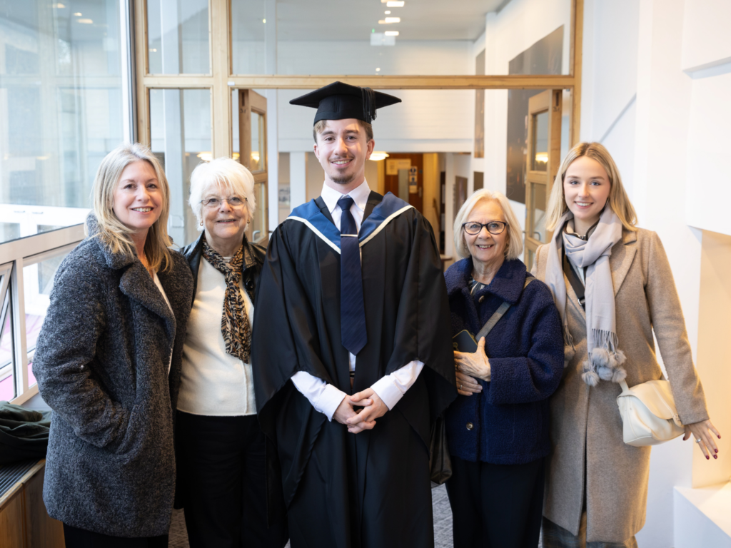 Graduand and his family members pose for a photo 