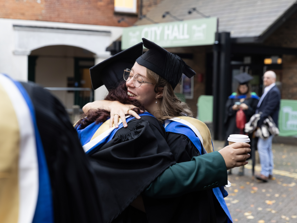 Two graduands hugging each other outside Salisbury playhouse 