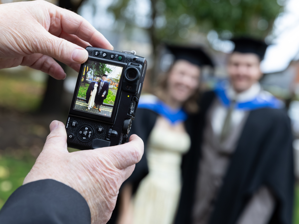 Someone taking a photo of two graduands