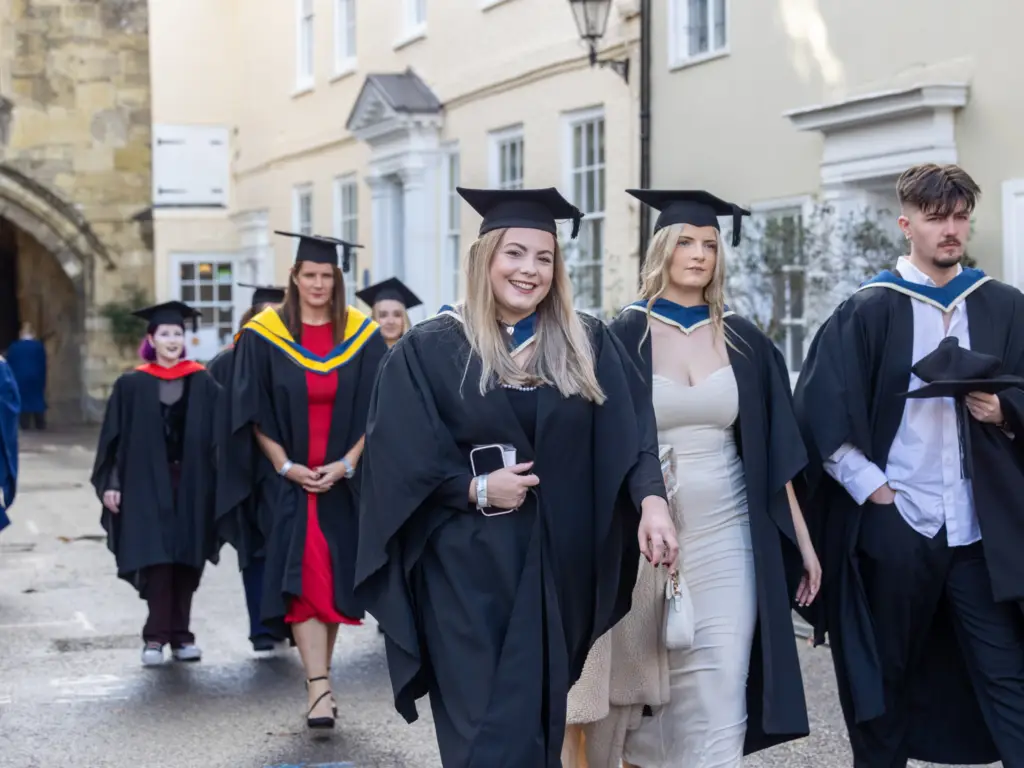 Graduands walking through the cathedral grounds 