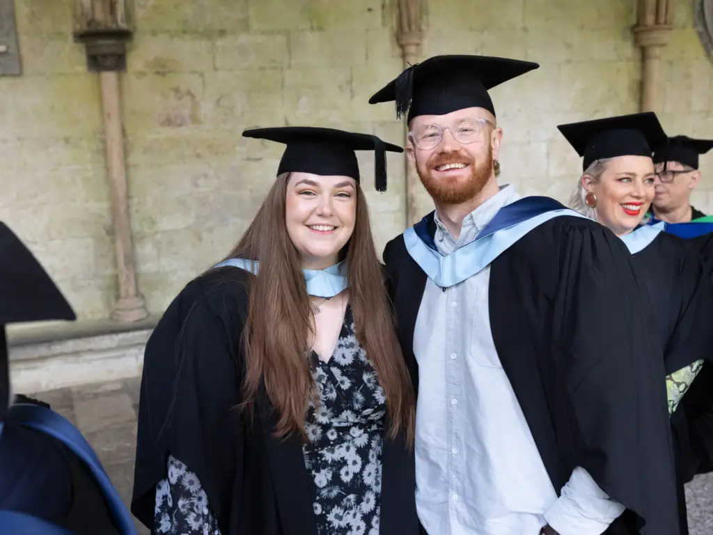 Two graduands waiting to go in at salisbury cathedral 